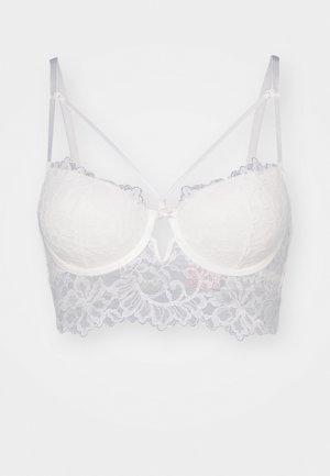 Čipkast bralet u bijeloj boji s podstavljenim kupovima. Ima cvjetni uzorak, podesive satenske trakice i detalj s otvorom sprijeda.