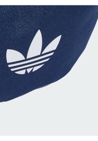 Navy fabric bag featuring a white Adidas logo with three leaves and three horizontal stripes above. The texture is smooth and woven.