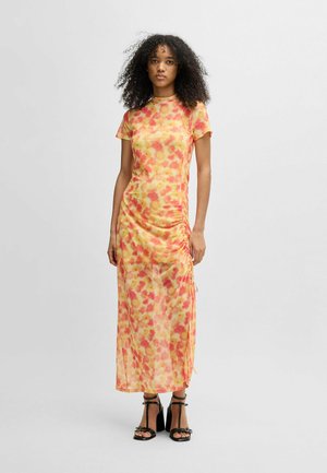 Lightweight, floral-patterned dress in orange and yellow. Features short sleeves, ruched sides, and a long, flowing silhouette.