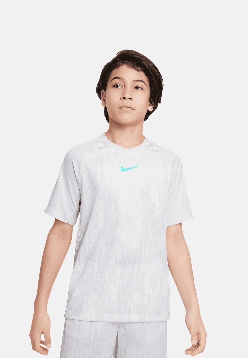 Camiseta deportiva blanca de Nike de manga corta, con un sutil patrón texturizado, que presenta un logo en turquesa claro en el pecho, fabricada con un tejido transpirable.