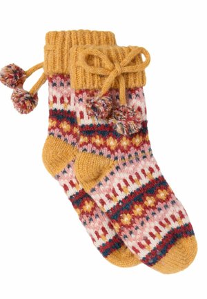 Gebreide wollen sokken met mosterdgele boorden, hielen, tenen en een meerkleurig patroon op het lichaam, versierd met pompons en gestrikte strikjes.