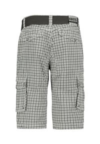Cargo shorts in a black and white checker pattern, featuring side pockets, a stretchy waistband, and button accents for utility.