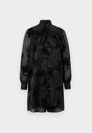 Blusa nera trasparente con ricami floreali, colletto alto e dettaglio con fiocco. Maniche lunghe con polsini arricciati. Tessuto leggero e fluido.