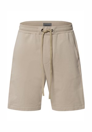 Pantalones cortos beige hechos de una tela suave, con una cinturilla elástica con cordón, bolsillos laterales y un diseño de corte relajado.
