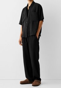 Bershka Tygbyxor - black