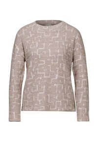 Beige tröja med ett texturerat mönster av vita geometriska former, rund halsringning och långa ärmar, tillverkad av ett mjukt stickat material.