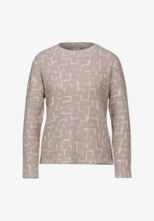 Beige trui met een gestructureerd patroon van witte geometrische vormen, ronde halslijn en lange mouwen, gemaakt van een zacht gebreid materiaal.