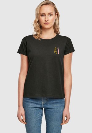 Black t-shirt made of cotton with short sleeves, featuring a colorful "hi" graphic design on the left chest. Simple, relaxed fit.