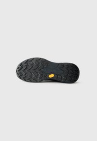 Sort gummisål med et struktureret mønster for godt greb og et gult Vibram-logo. Har fleksibelt design og holdbar konstruktion.
