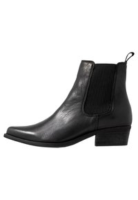 Bottine en cuir noir avec panneau latéral élastique, bout arrondi et talon bas. Texture lisse avec un minimum de détails de couture.