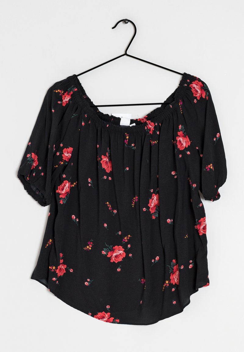 Black floral blouse with short, puffed sleeves. Features red roses and small flowers on a sheer fabric. Elastic neckline with a loose fit.