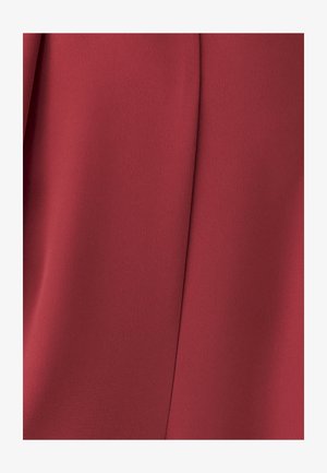 Red fabric with a smooth texture and slight sheen. Features subtle folds and a structured design, creating a clean, elegant appearance.