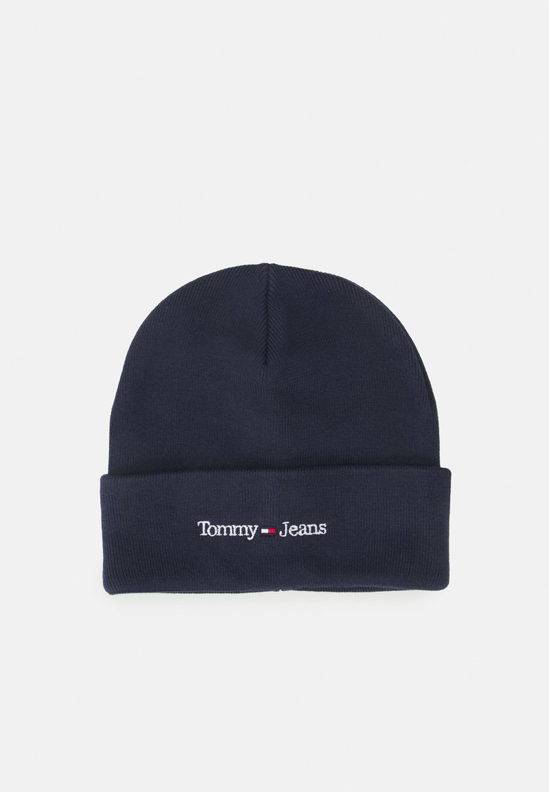Bonnet en tricot bleu marine avec un revers, portant un texte brodé blanc "Tommy Jeans" et un petit accent logo rouge.