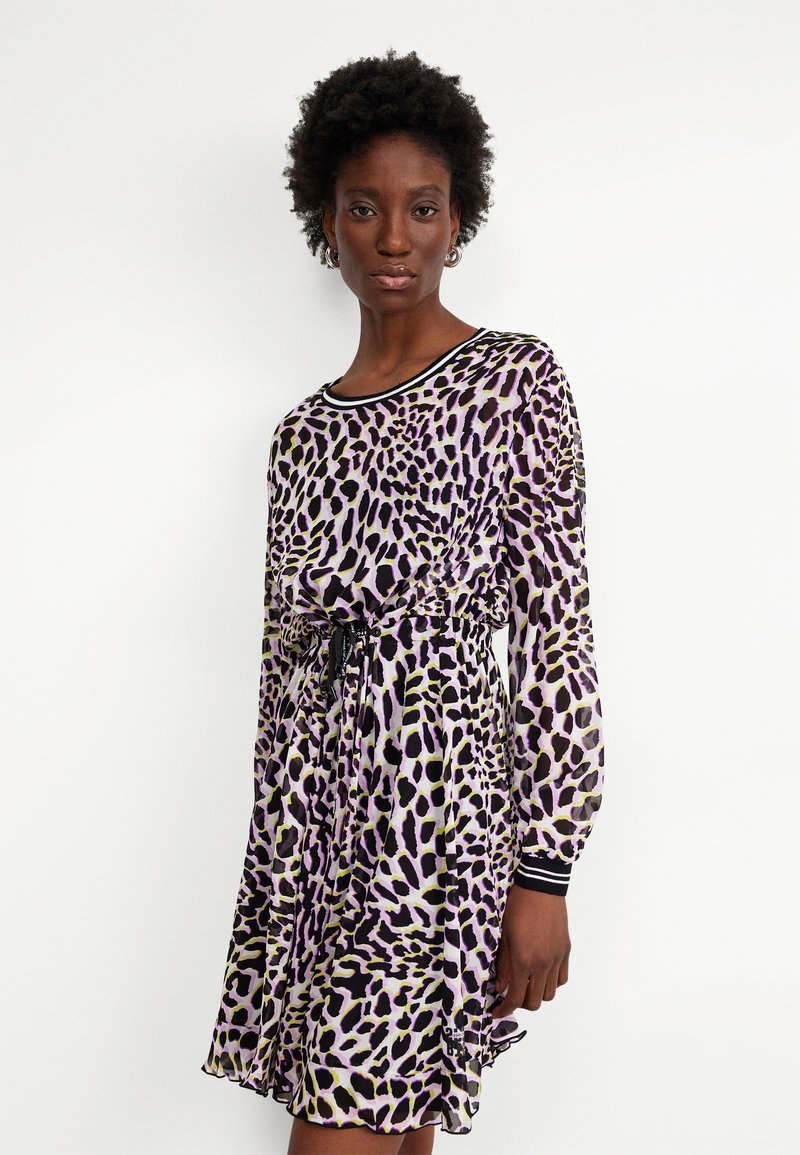 Purple and black leopard print dress, with long sleeves, a relaxed fit, and an adjustable drawstring waist. Sheer fabric with ribbed collar.