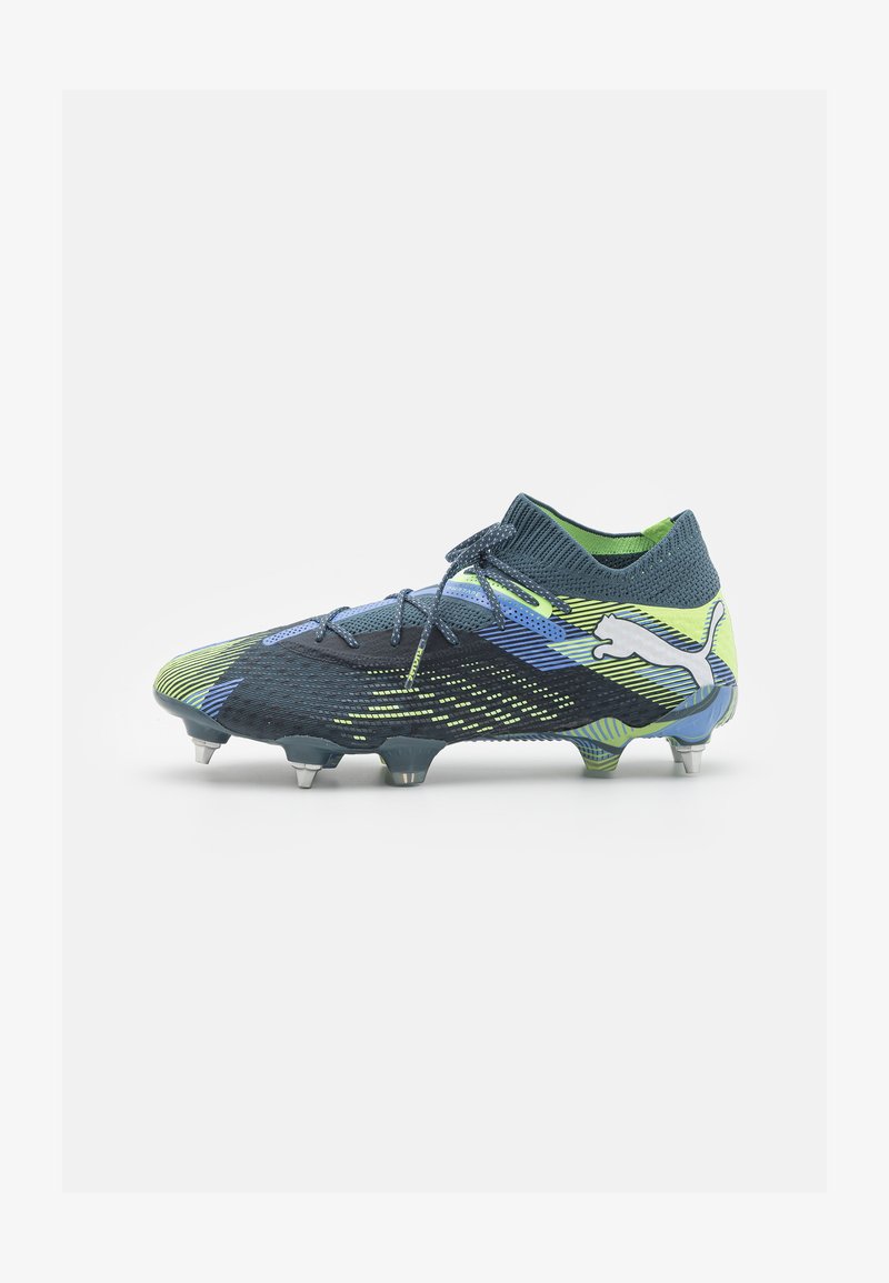 Blue and green football boot with a textured mesh upper, curved design, and metallic studs. Puma logo in white on the side.
