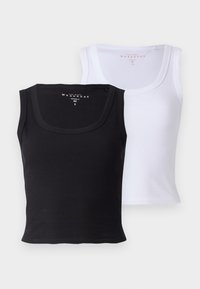 Two cotton tank tops, one black and one white. Both feature a ribbed texture, wide necklines, and a fitted shape.