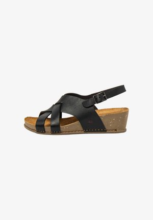 Sandale compensée en cuir noir pour femme avec bride réglable à boucle, semelle en liège et semelle cousue, comportant des brides croisées à l'avant.