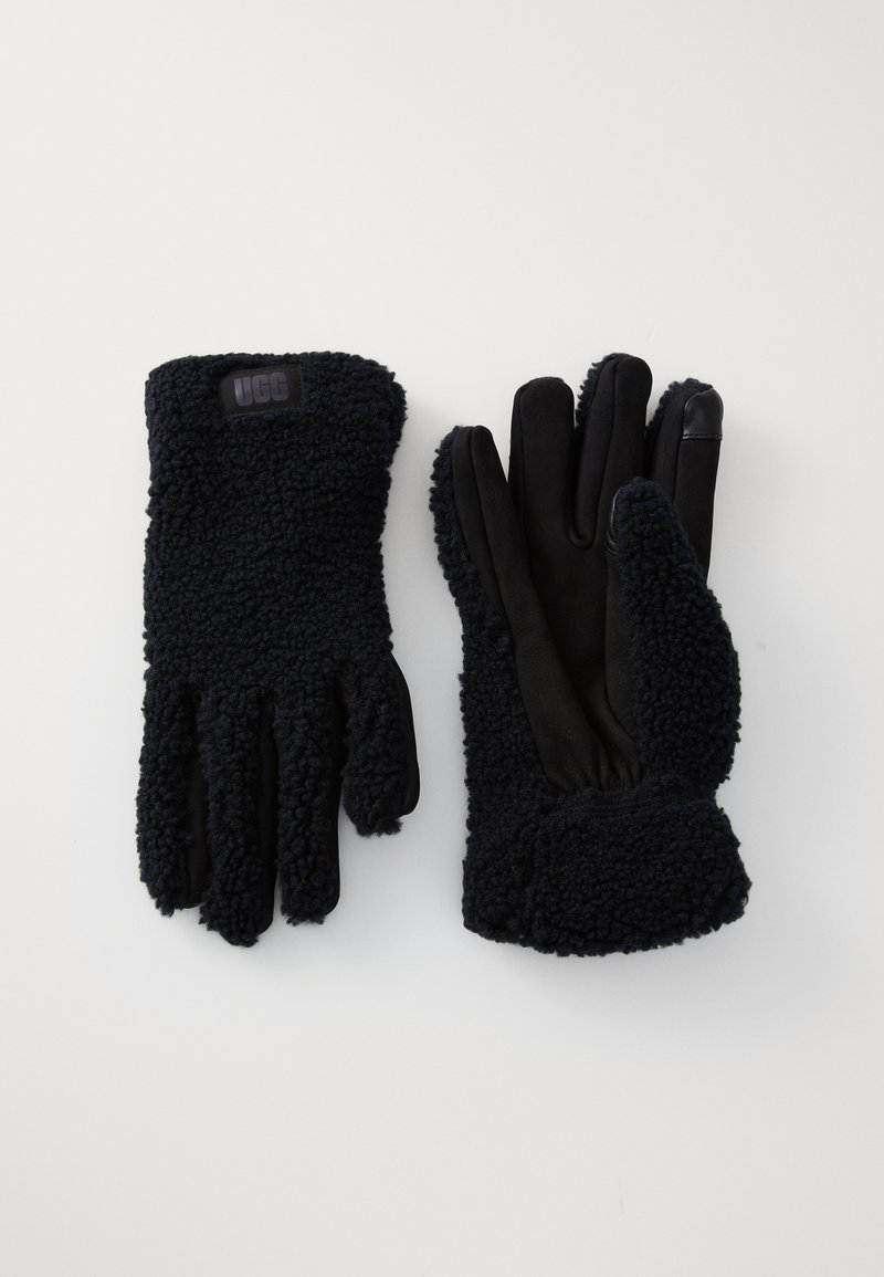 Black gloves featuring a textured, fluffy exterior and smooth black inner lining. Includes a logo patch and fitted wrist design.