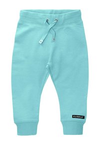 Jasnoniebieskie bawełniane dresy z elastycznym pasem, regulowanym sznurkiem, ściągaczami na kostkach i czarną metką marki na dolnej nogawce.