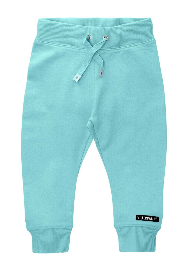 Jasnoniebieskie bawełniane dresy z elastycznym pasem, regulowanym sznurkiem, ściągaczami na kostkach i czarną metką marki na dolnej nogawce.