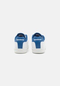 Hvite sneakers med blå detaljer. Laget av glatt lær, med polstret krage og hæl, samt Reebok-logoen bak. Gummisåle.