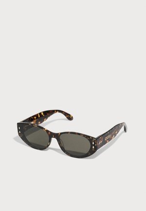 Sunglassi iz želve s temno sivo lečo, pravokotne oblike in majhnimi okrasnimi nitki spredaj. Teksturni zaključek na ročajih.