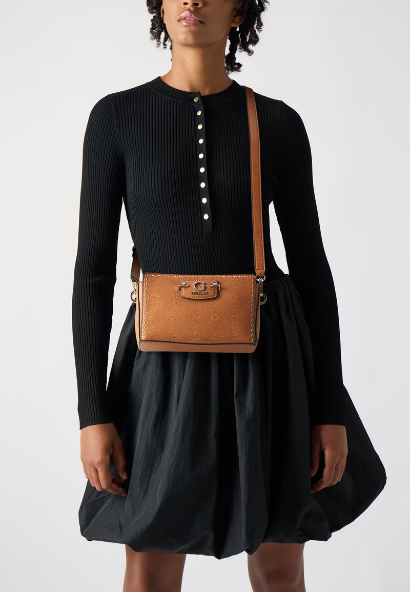 Brown leather crossbody bag with a textured finish, silver hardware, and contrasting white stitching. Features a stylish clasp and adjustable strap.