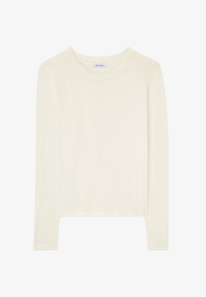 Kerma-vaaleanvärinen pitkähihainen pyöreäkauluspaita, jossa on suora helma ja pieni merkkilappu kauluksen sisäpuolella.