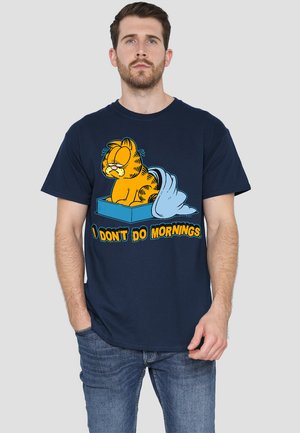 Navy T-shirt featuring a cartoon cat with yellow stripes, text "I DON'T DO MORNINGS," short sleeves, and a classic fit.