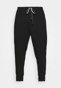 Svarta sweatpants med en taperad design, elastisk midja och vit dragsko. Har två sidofickor och ribbade mudd. Blandning av bomullsmaterial.