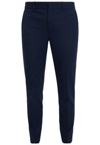 Lahkeet siniset housut sileästä kankaasta, joissa on litteä etuosa, vyölenkit ja kapenevat lahkeet räätälöityä ilmettä varten.