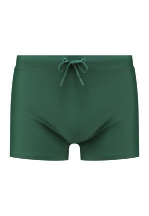 Dunkelgrüne Badeshorts mit einem Kordelzugbund, glatter Textur und einem figurbetonten Design. Mit minimalem Branding an der unteren rechten Seite.