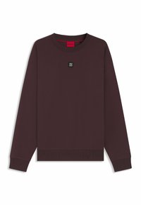 Maroon sweatshirt with a crew neckline, long sleeves, and ribbed cuffs. Features a small black logo patch at the chest and a red interior tag.