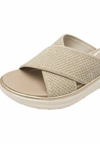 Sandales à glissière beiges avec des brides croisées texturées, une semelle intérieure douce et une semelle légère. Le matériau présente un motif tissé avec un éclat subtil.