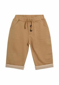 Shorts en coton beige avec taille élastique, cordon de serrage, deux poches et ourlet retroussé, présentant un accent texturé marron clair.