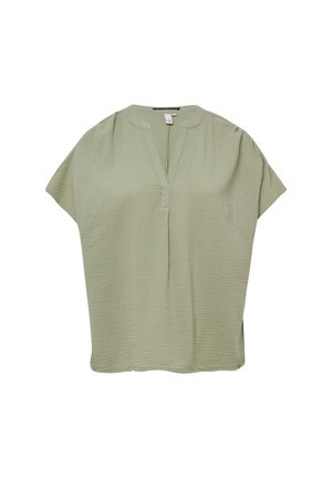 Short-sleeve, V-neck top in light green, made from textured fabric with subtle puckering, and side slits for ease of movement.