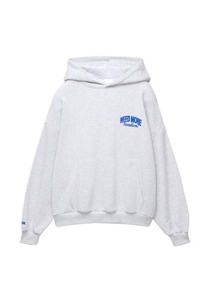 Gray hooded sweatshirt with a front kangaroo pocket, featuring blue text "NEED MORE Vacation" on the left chest and ribbed cuffs.