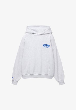 Grå huvtröja med en framficka i känguru-stil, med blå texten "NEED MORE Vacation" på vänster bröst och ribbade ärmslut.