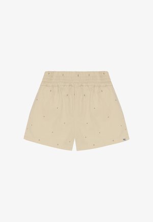Beżowe szorty z elastycznym pasem, ozdobione małymi, równomiernie rozmieszczonymi brązowymi kropkami oraz metką z logo na dolnej części boku.