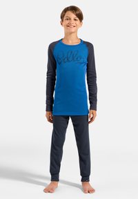 Blue long-sleeve top with dark gray sleeves featuring a textured "Hello" print, paired with dark gray pants, both in a soft fabric.