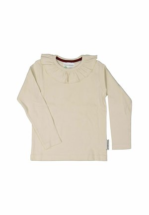 Pitkähiha beige paita, jossa on ribattu pinta ja hulmuava kaulus. Sivussa oleva etiketti näyttää brändin nimen. Rentoa muotoilua.