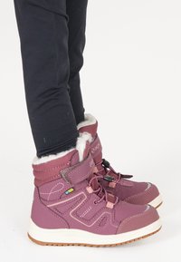 Bottes violettes imperméables avec doublure en fourrure, lacets réglables et semelles en caoutchouc. Présente des surfaces lisses et texturées avec des chevilles renforcées.