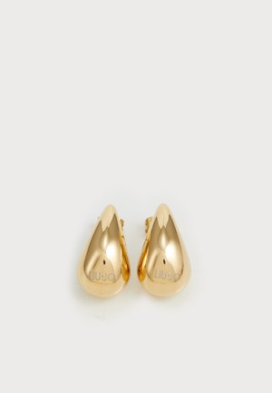Boucles d'oreilles en métal doré en forme de goutte d'eau, avec une surface lisse et brillante, portant le logo "LIU JO" gravé sur un côté.