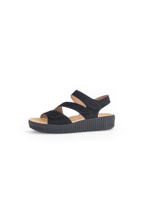 Black suede sandals with cross straps, a textured platform sole, and padded footbed for comfort. Features a slip-on design.