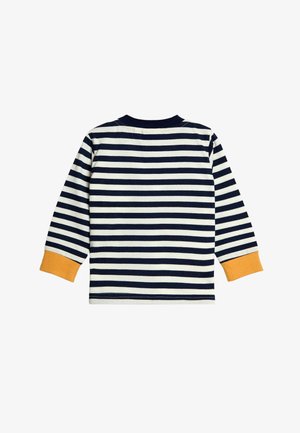 Navy ja cream väride riba pikkade varrukatega särk, mille mansetid on sinepikollased. Puuvillane kangas, ümar kaelus, ühtlase horisontaalse riba mustriga.