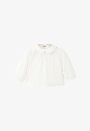 Blouse blanche bébé à manches longues avec col Peter Pan et plis subtils à l'avant, en tissu léger.