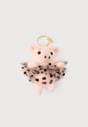 Porte-clés en peluche en forme de cochon avec un charme d'aile dorée, tutu noir à pois blancs, tenant une petite baguette dorée avec une étoile au bout, sur fond blanc.