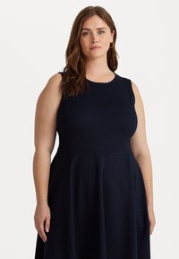 Navy sleeveless dress with a round neckline. A-line silhouette, knee-length, smooth fabric, and subtle seam detailing on the bodice.