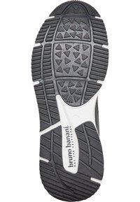 Gumeni potplat cipele s geometrijskim uzorkom u crno-bijeloj boji, s trokutastim i pravokutnim utorima za poboljšano prianjanje.