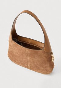 Bolso bandolera de ante marrón con una correa de cuero color beige, que incluye un detalle de logo dorado y un bolsillo interior con cremallera. Textura suave y forma curva.